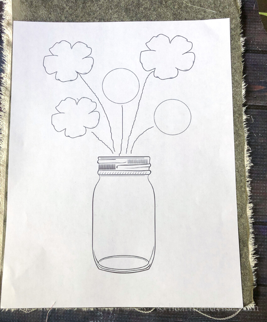 Mason jar vase with flower graphic traced with carbon paper on canvas fabric.