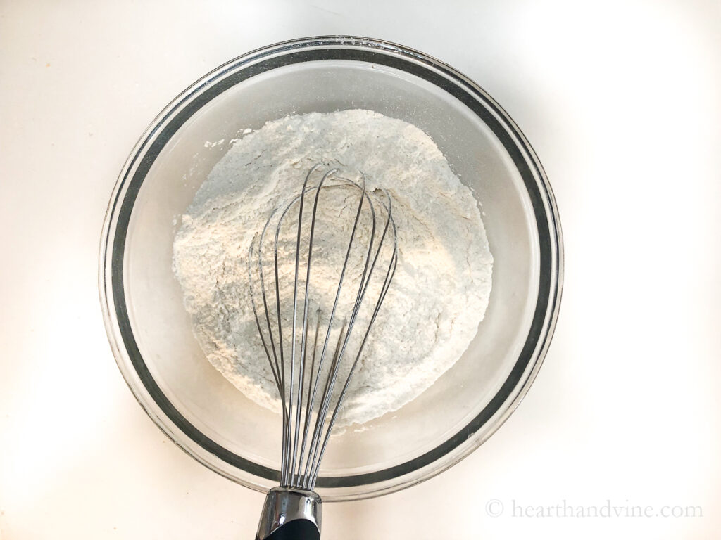 Mixing dry ingredients with a whisk.