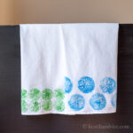 Two fruit stamped flour sack towels
