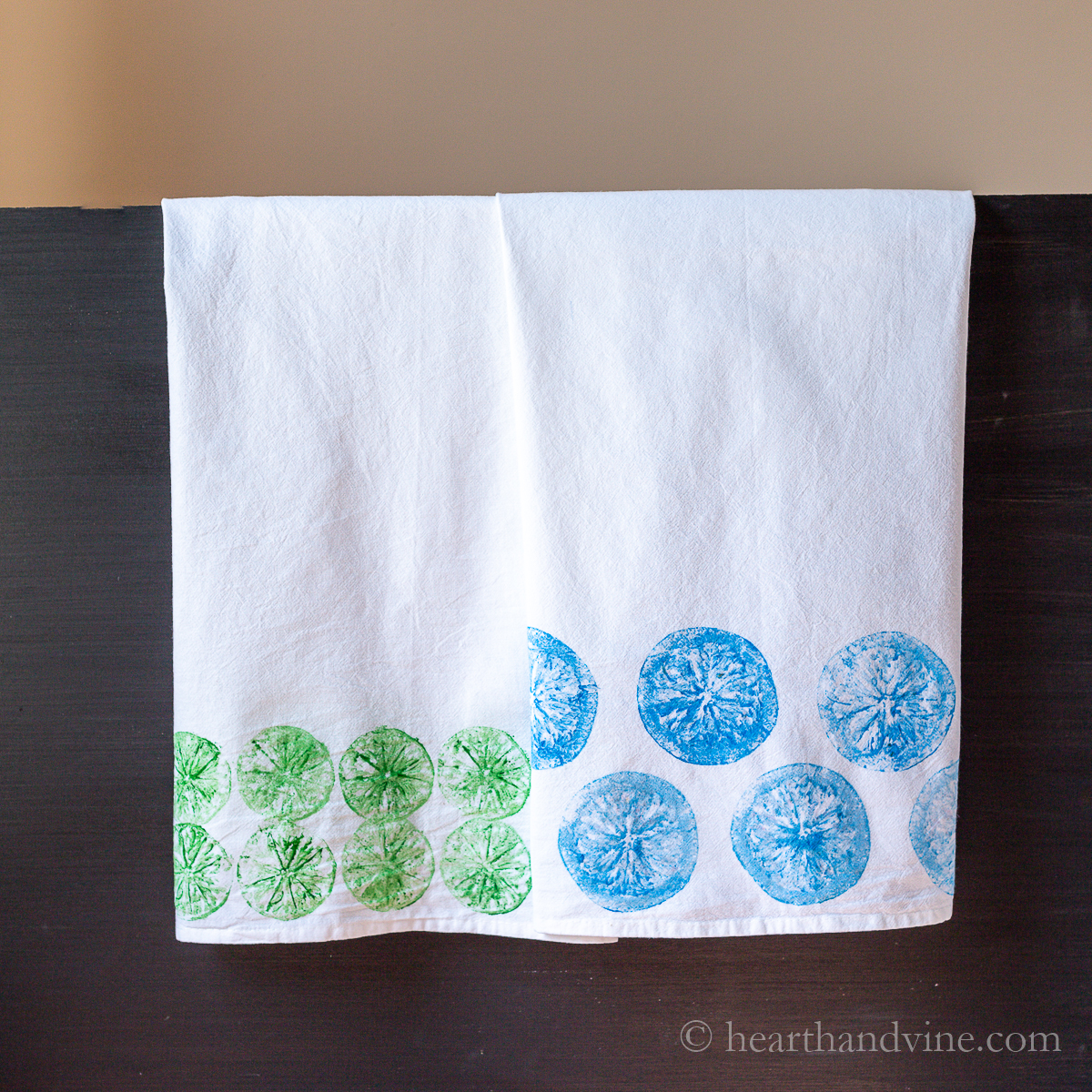 Two fruit stamped flour sack towels
