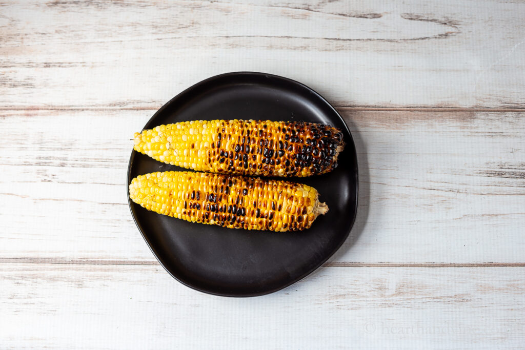 Plate of two ears of corn grilled.