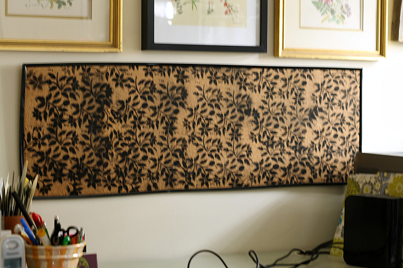 Black floral printed bulletin board hung on the wall.