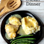 Chicken dinner with mashed potatoes and green beans.