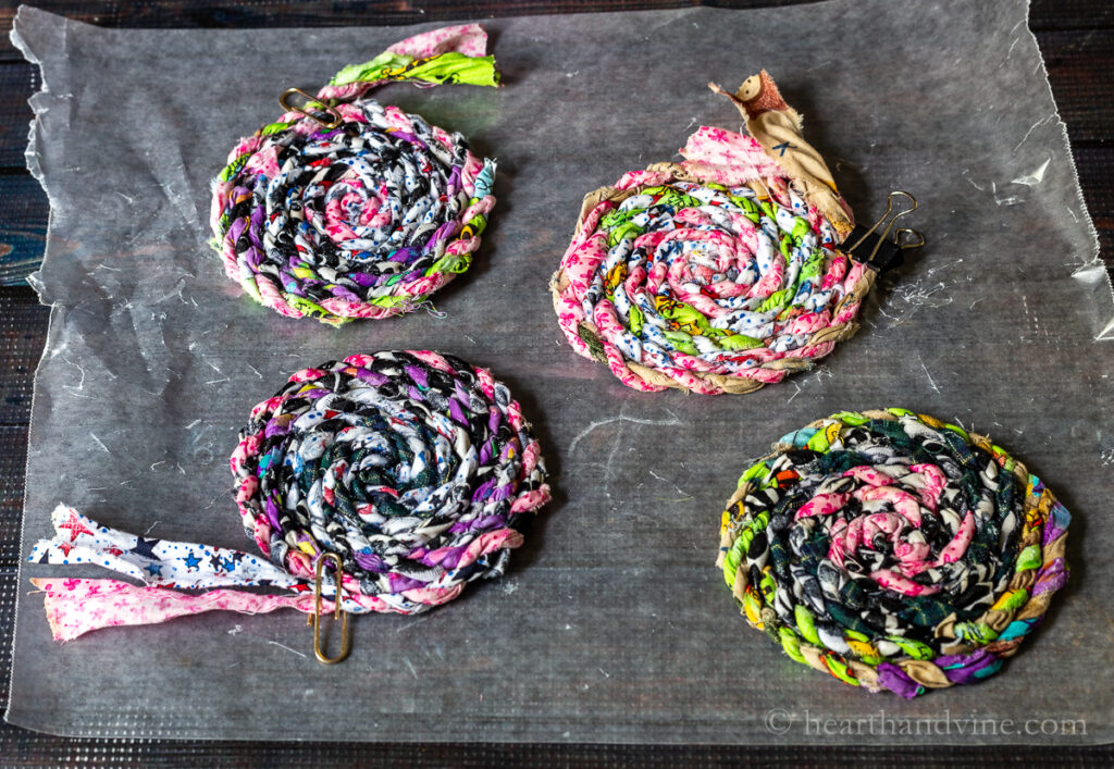 Fabric coasters drying on wax paper.