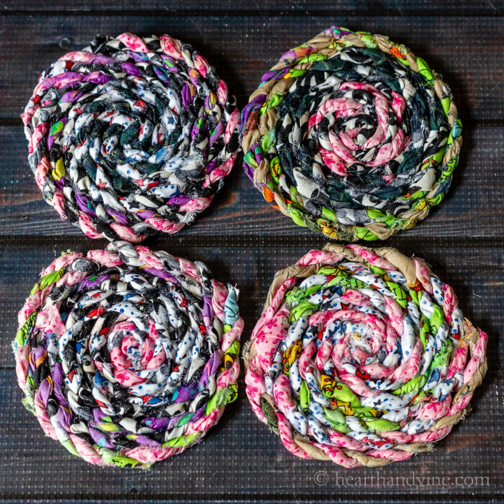 Four colorful fabric coasters made from fabric twine.