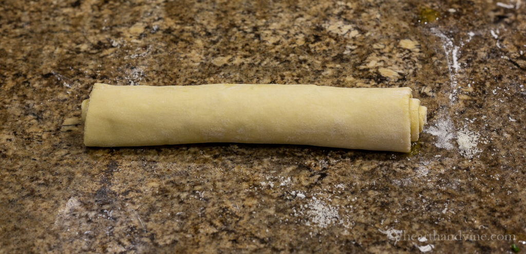 Puff pastry with herbs and oil rolled up.