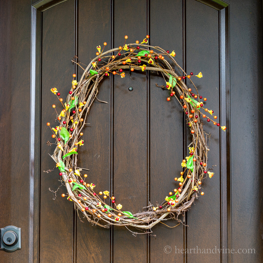 Fall bittersweet and grapevine wreath on front door.