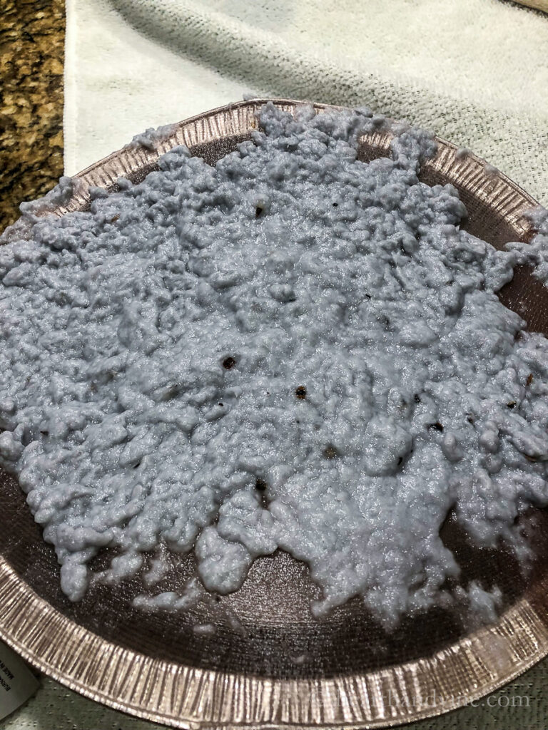 Wet paper pulp with seed on a sieve.