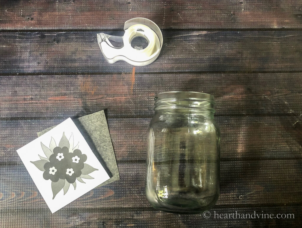 Pint mason jar, floral pattern, carbon paper and tape.