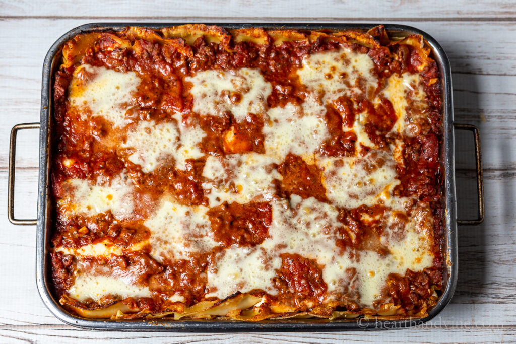 Large pan of homemade lasagna with Italian sausage and ground beef.