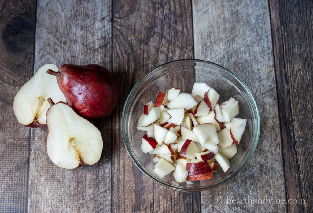 Red pears and chopped red pears in a bowl.
