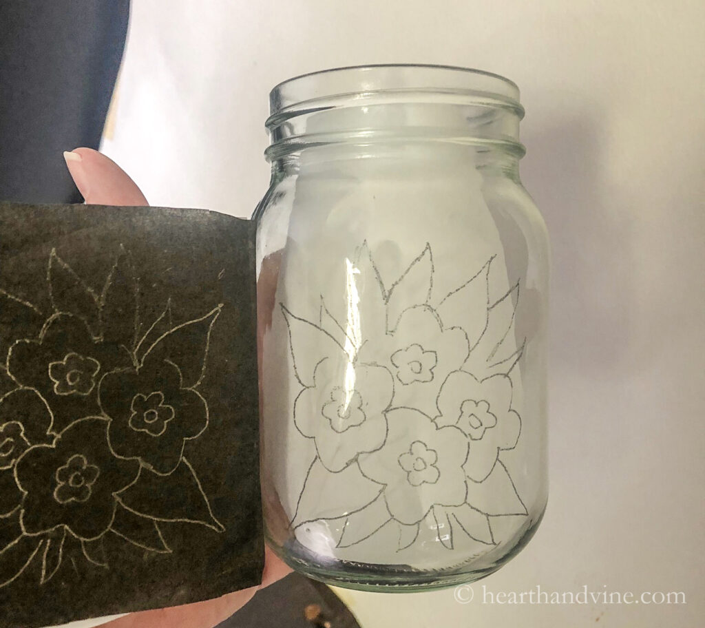 Floral pattern transferred onto a mason jar with carbon paper.