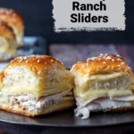Two turkey and cheese sliders on a plate