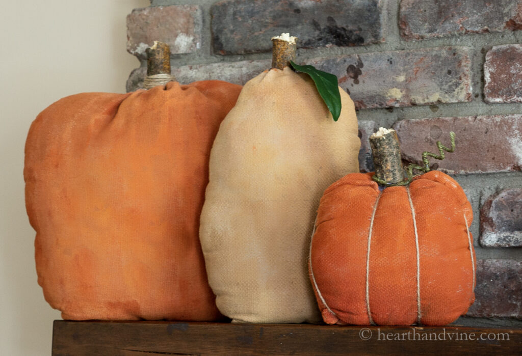 Primitive fabric pumpkins on the mantel.