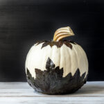 Mod podge pumpkin with black garden leaves.