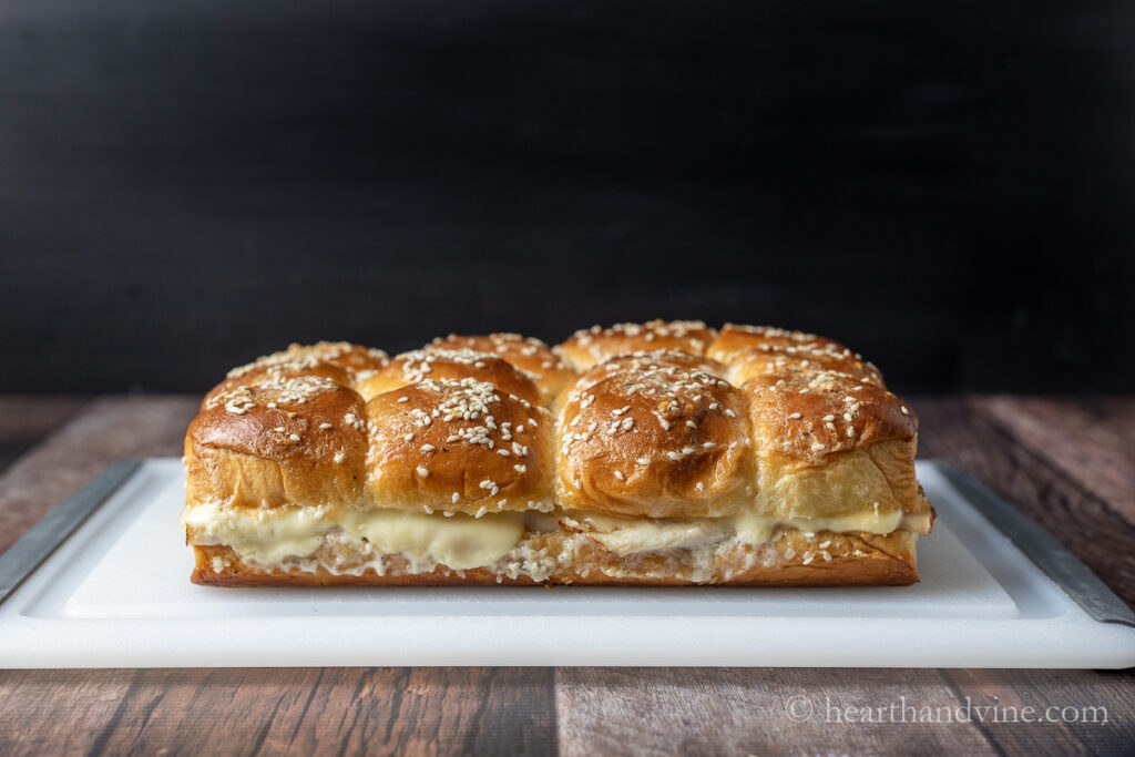 Turkey slider loaf baked and set on a cutting board to slice or separate.