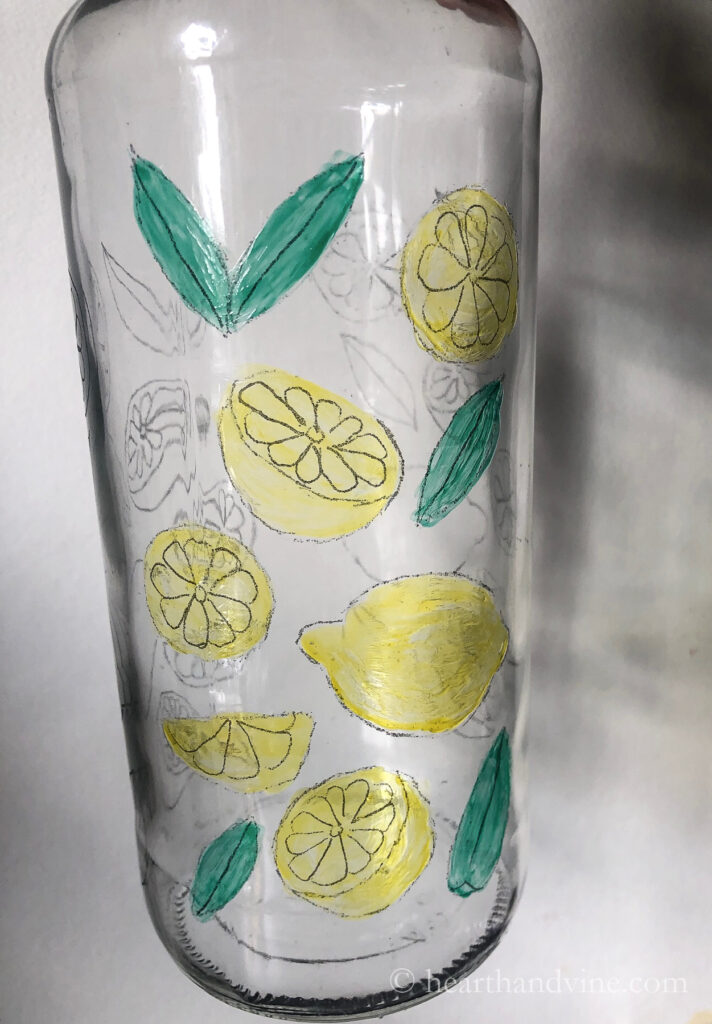 Lemons and leaves bottle art painting on a clear wine bottle.