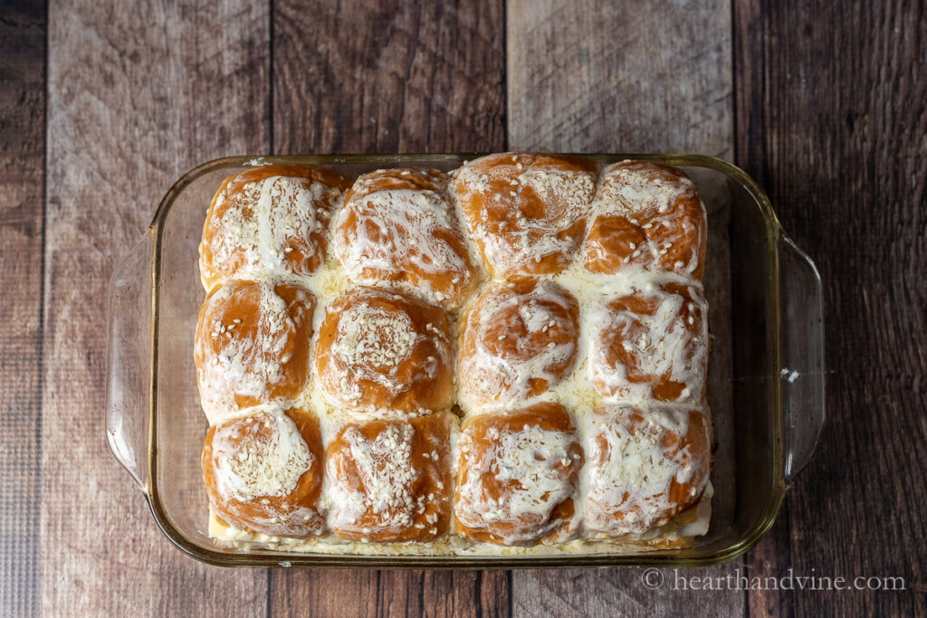 Turkeys sliders in a glass pan with ranch sauce pour over top.