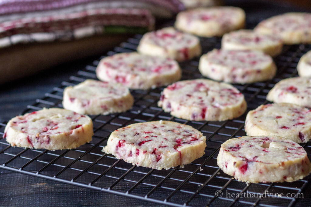 Baked fresh cranberry shortbread cookies on a cooling rack.