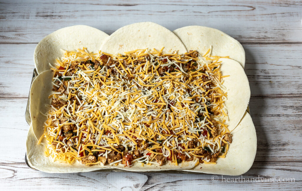 Final layer of shredded cheese on top of the chicken and vegetable mixture.