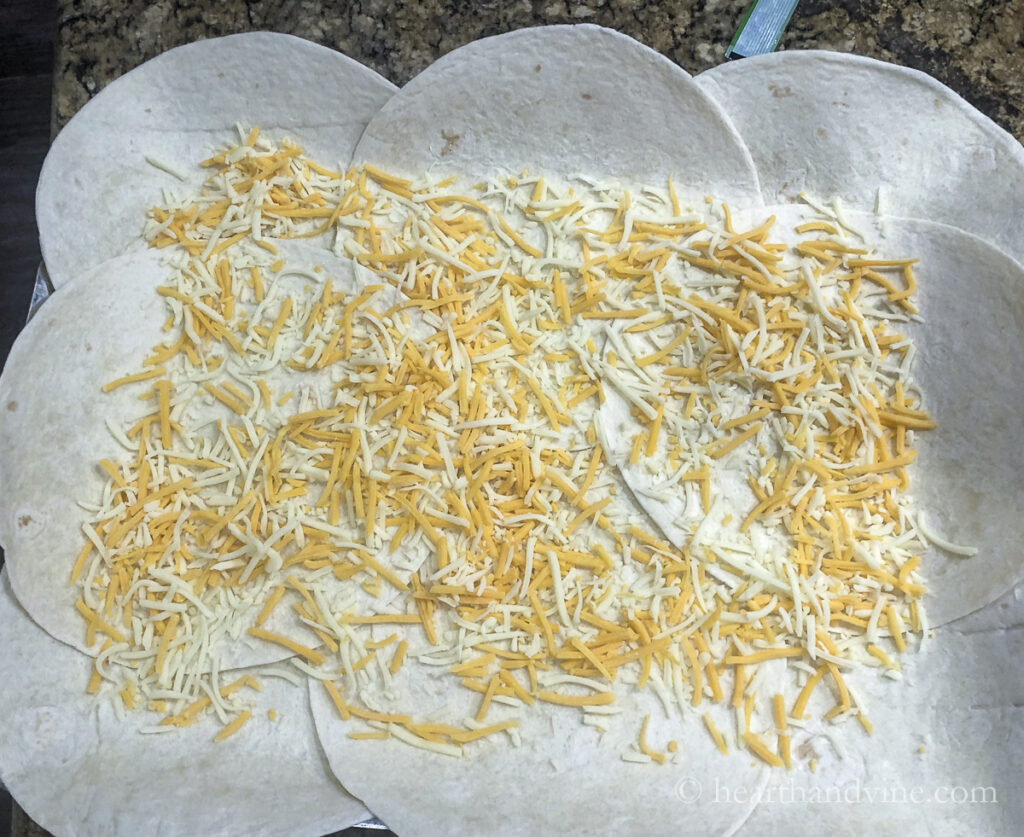 Shredded cheese on top of the tortilla layer.