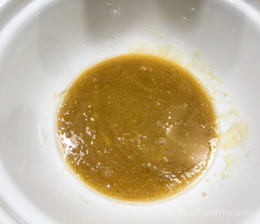 Olive oil and brown sugar in a bowl.