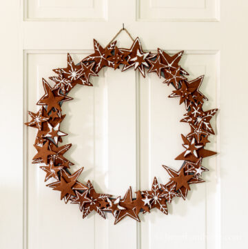 Applesauce cinnamon ornament wreath on a white door.