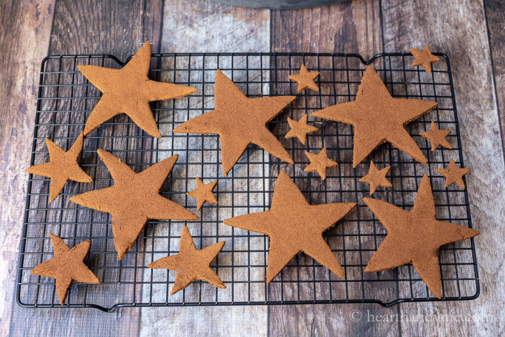 Cinnamon applesauce star ornaments on a cooling rack.