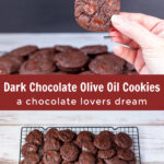 Hand holding chocolate cookie over a tray of olive oil chocolate chip cookies
