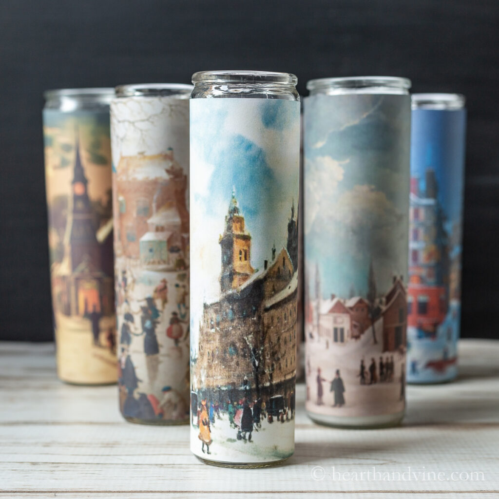 Glass candles with vintage winter scenes.