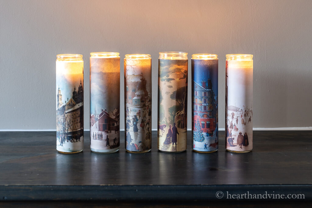 Six vintage candle luminaria lit.