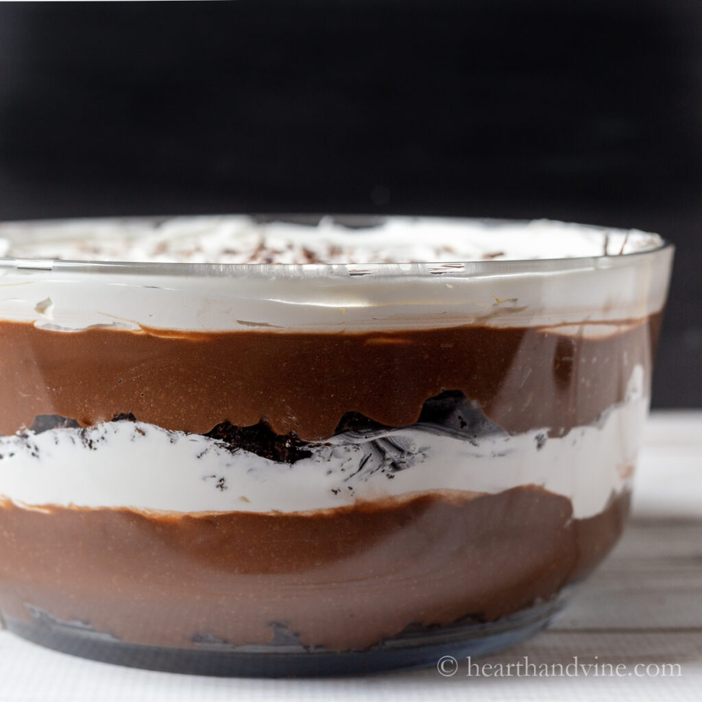 Side view of trifle showing layers of brownies, chocolate pudding and whipped topping.