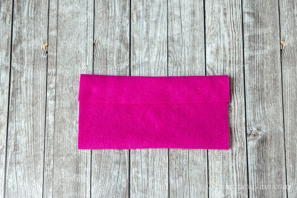 A 9 x 12 inch piece of pink felt folded up from the bottom and a smaller fold at the top.