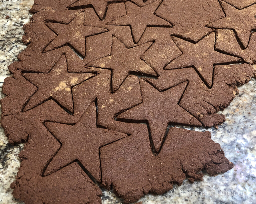 Cutting out stars from applesauce cinnamon dough.