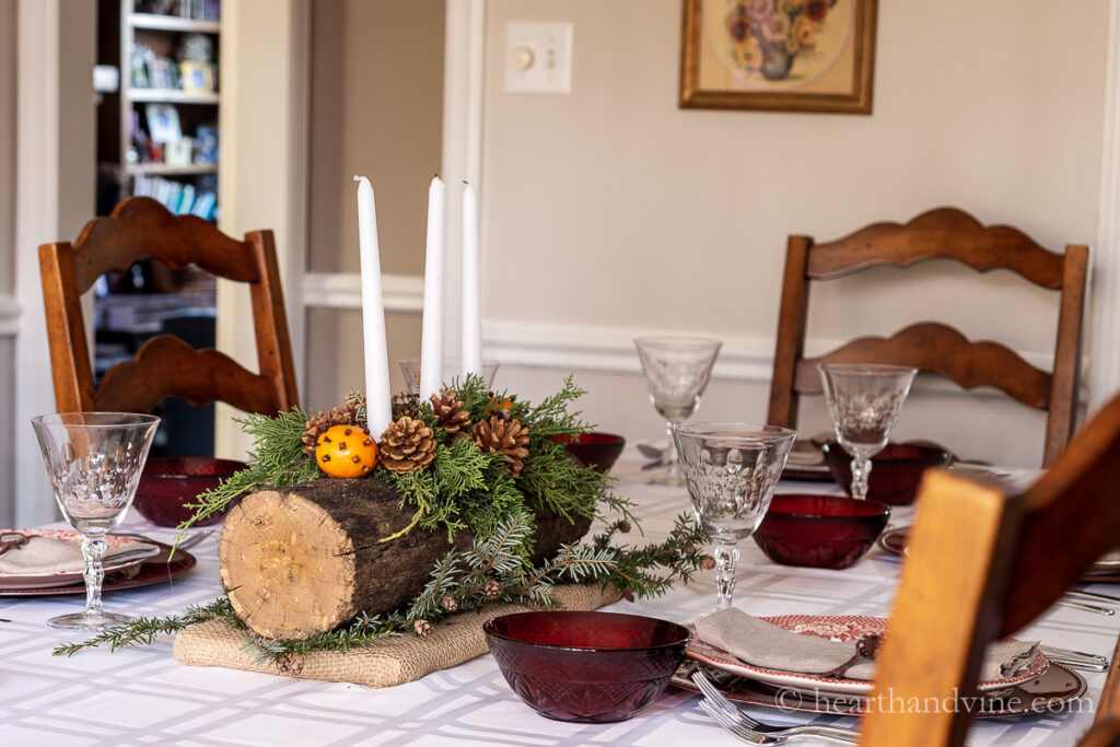 Christmas tablescape with a yule log centerpiece.