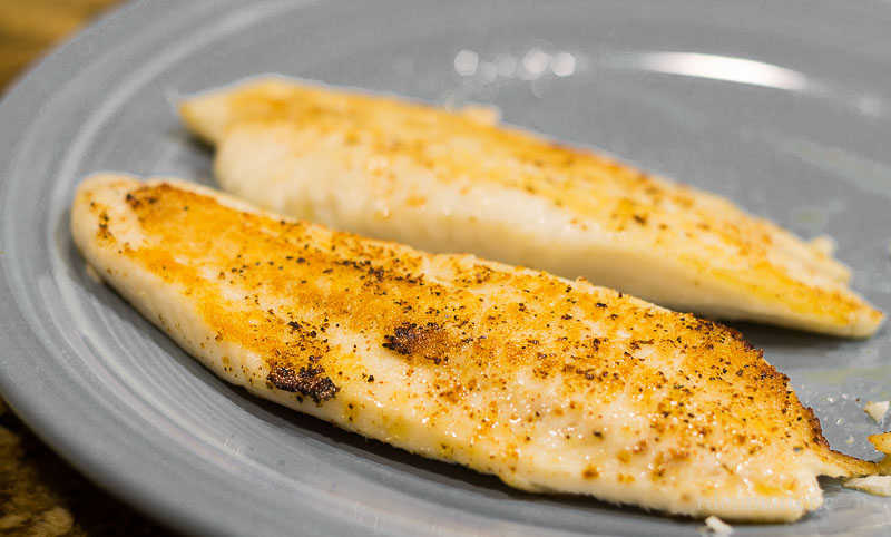 Two pan fried tilapia fillets.