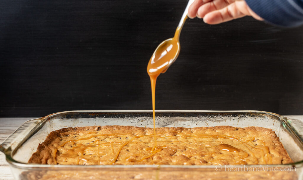 Caramel sauce drizzled on top of a pan of bar cookies.