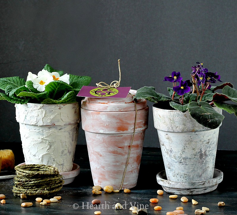 Three clay pots with paint and compound to make them look aged