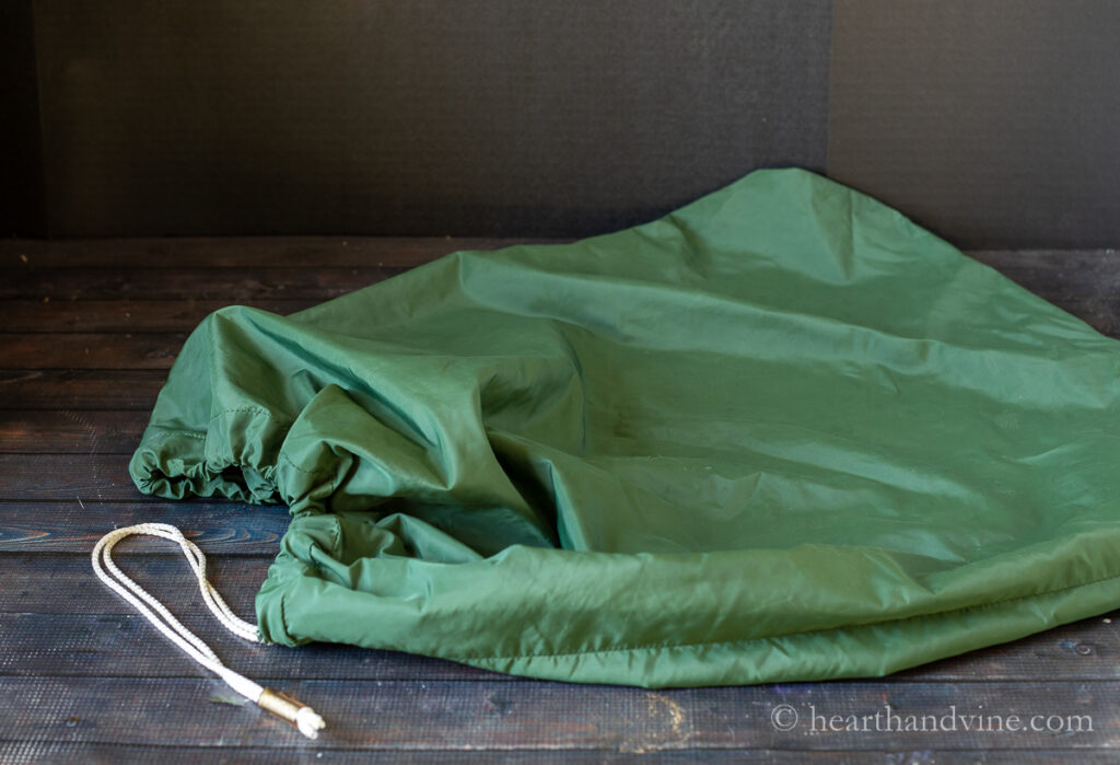 Green nylon drawstring laundry bag.