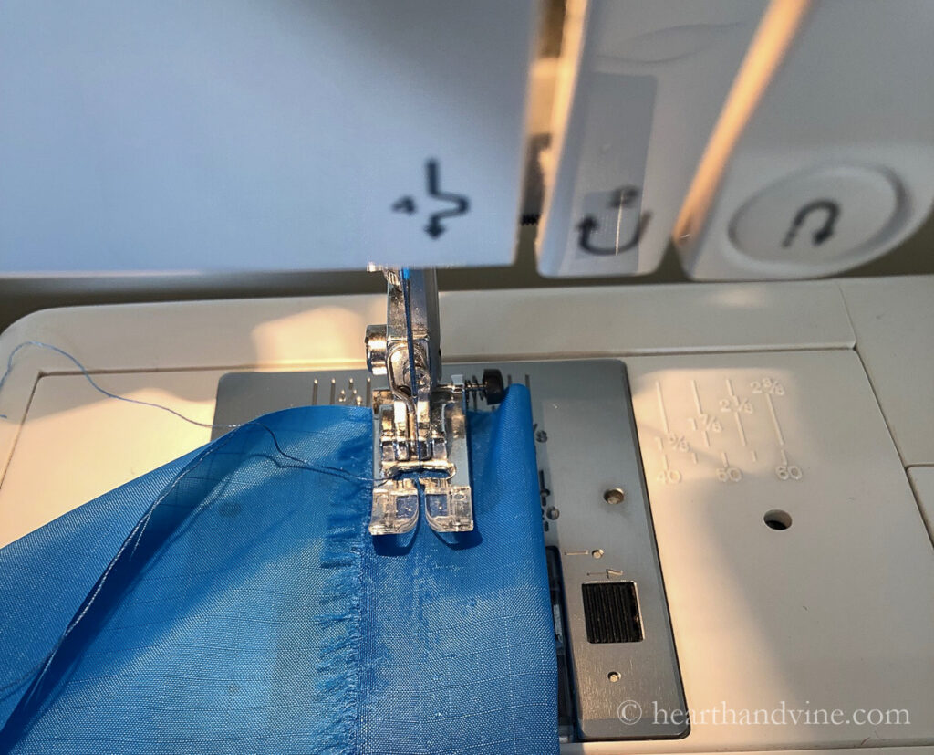 Sewing machine pressure foot sewing top folded edge.
