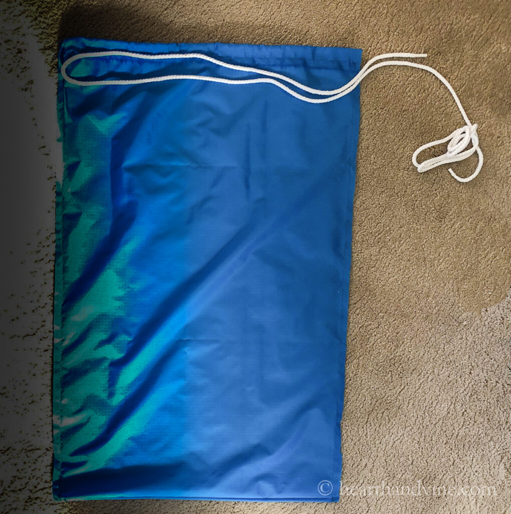 Double length of cording set on a blue nylon bag.