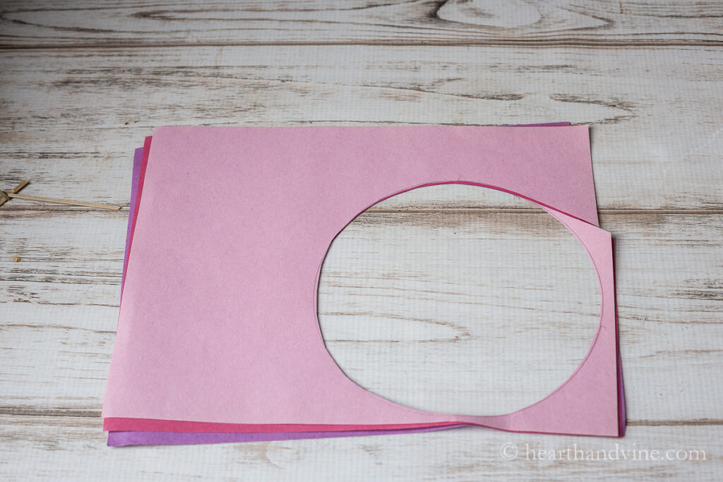 A circle cut out of three different colored paper.