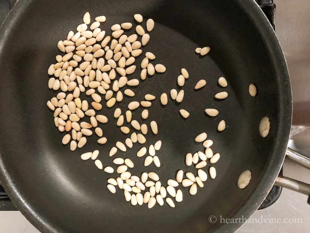 Roasting pine nuts on the stove in a non-stick pan.