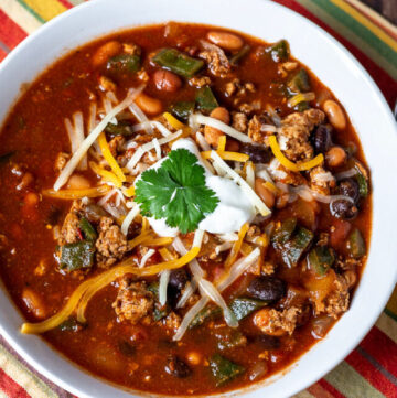 Bowl of ground turkey chili with poblanos and 3 beans.