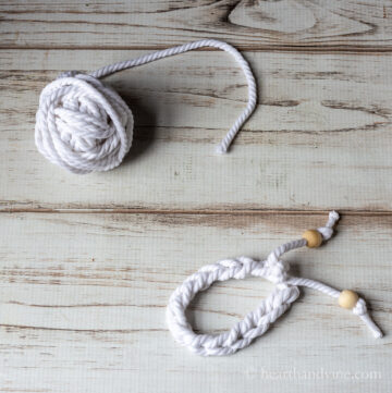 Ball of craft cord and a finger crochet bracelet with wood beads.