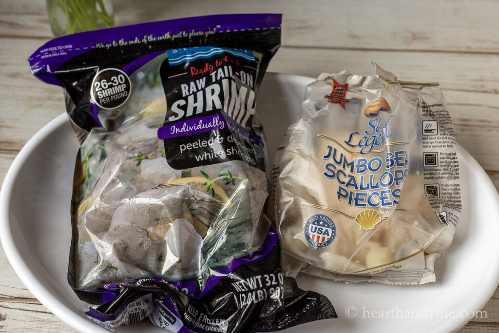 Bag of frozen shrimp and jumbo scallop pieces.