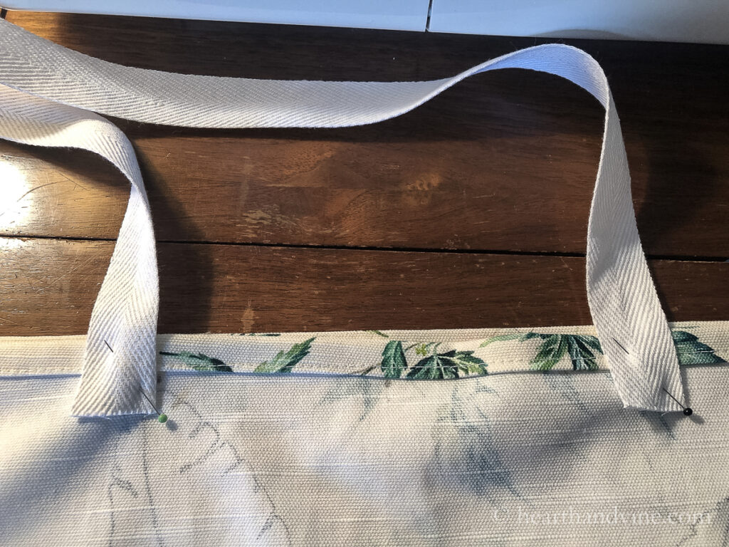 Pinning cotton straps to the inside of the bag.