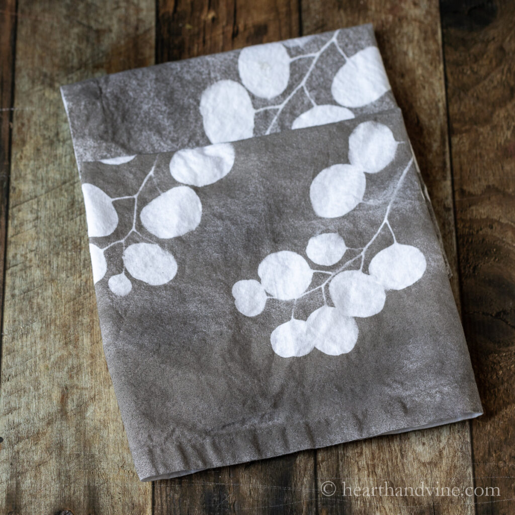 Gray napkins with white eucalyptus leaf printing.