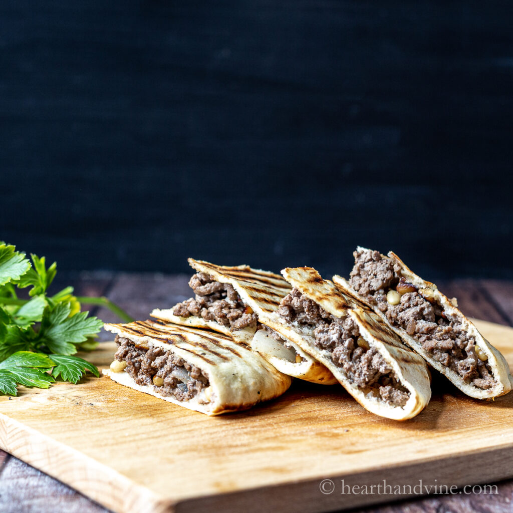 Pitas stuffed with meat mixture and grilled then cut into quarters.