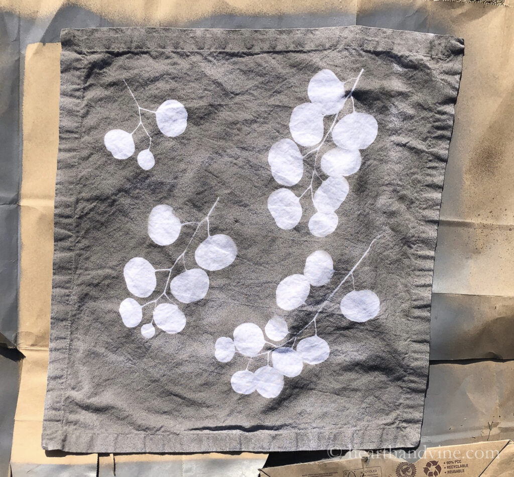 Eucalyptus leaves removed from spray painted napkin to reveal a beautiful negative space design.